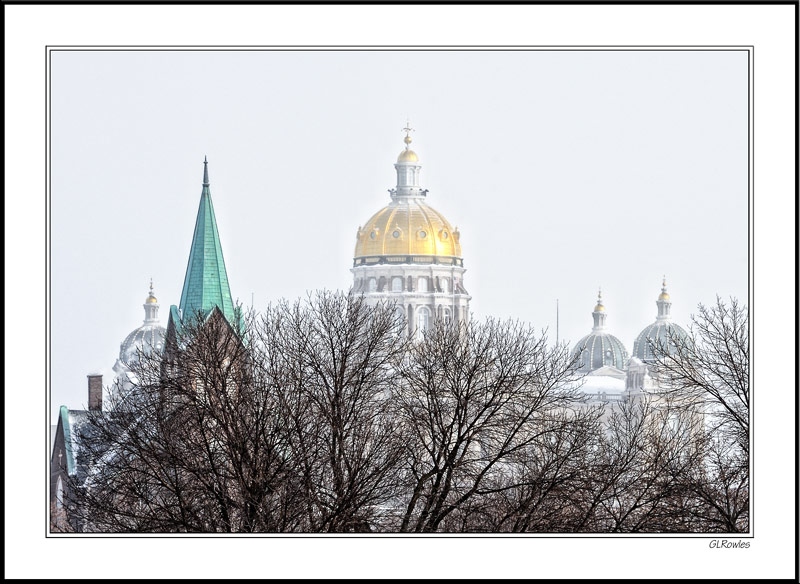 Snow-swept Capitol Spires Rise Above Winter's Barren Foliage