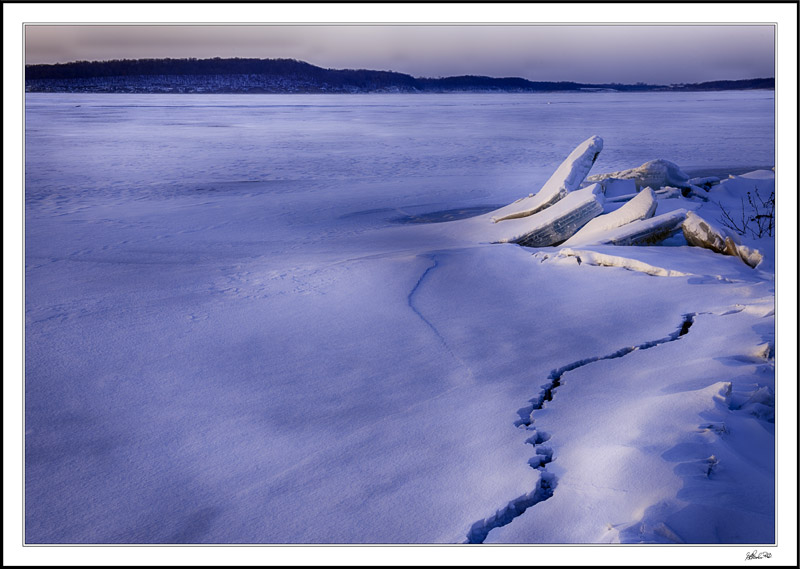 Muted Dawn Casts Soft Shadows, Highlighting Lake And Shore Textures