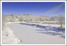 Winter Coated Landscape Beneath Sky Trails