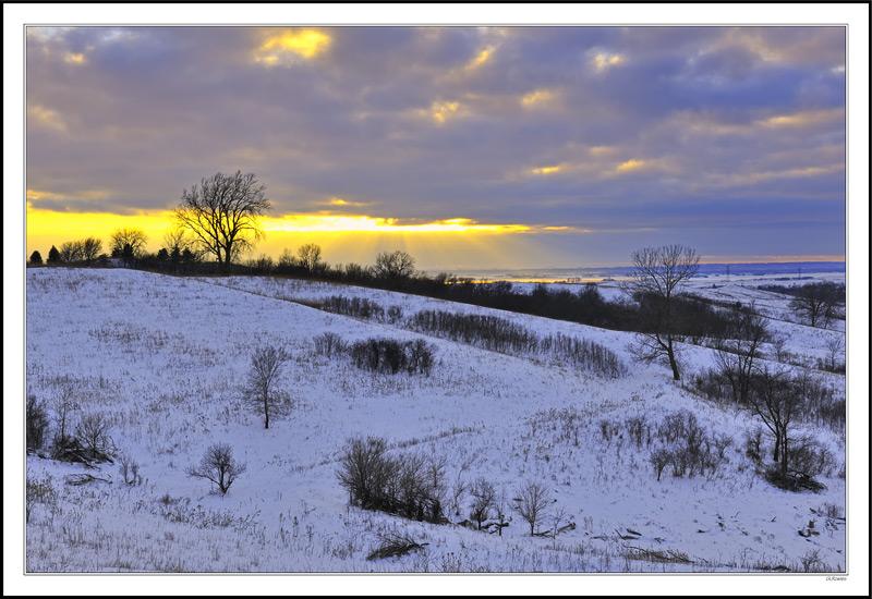 A Shaft Of Setting Sun Breaks In The Distant Valley